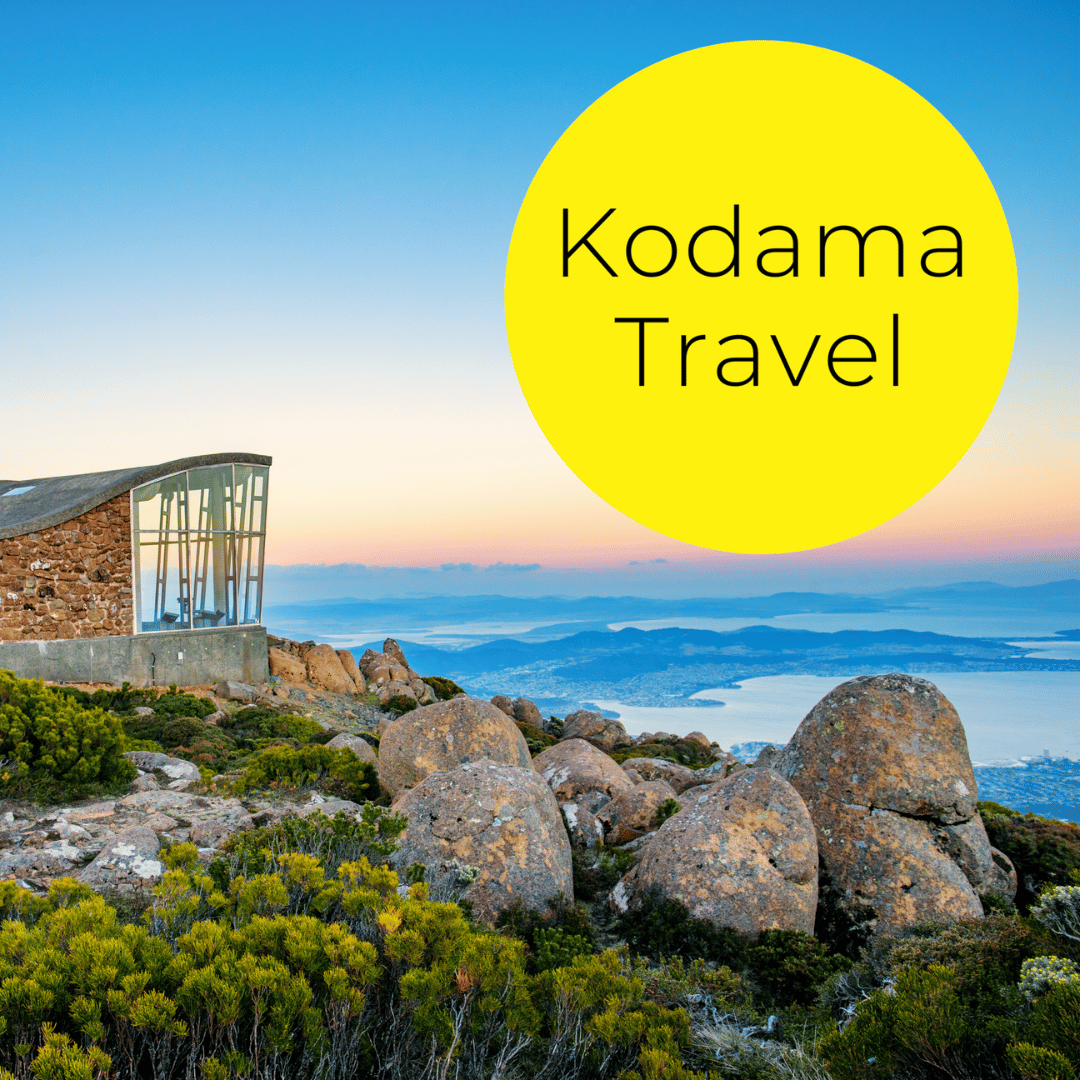 Kodama travel logo over a landscape at sunset.